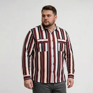 Man wearing a vertically striped shirt with red, white, and brown colors on a plain background
