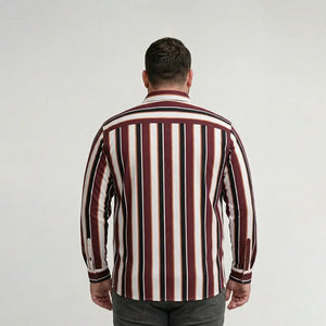 Man wearing a striped shirt from behind on a plain background