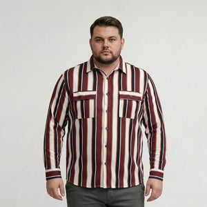 Man wearing a striped shirt against a plain background