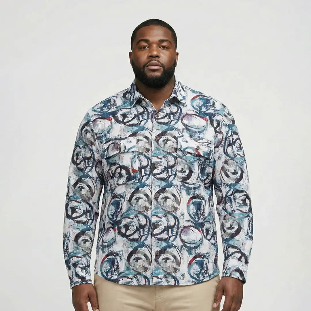 Man wearing a patterned shirt against a plain background