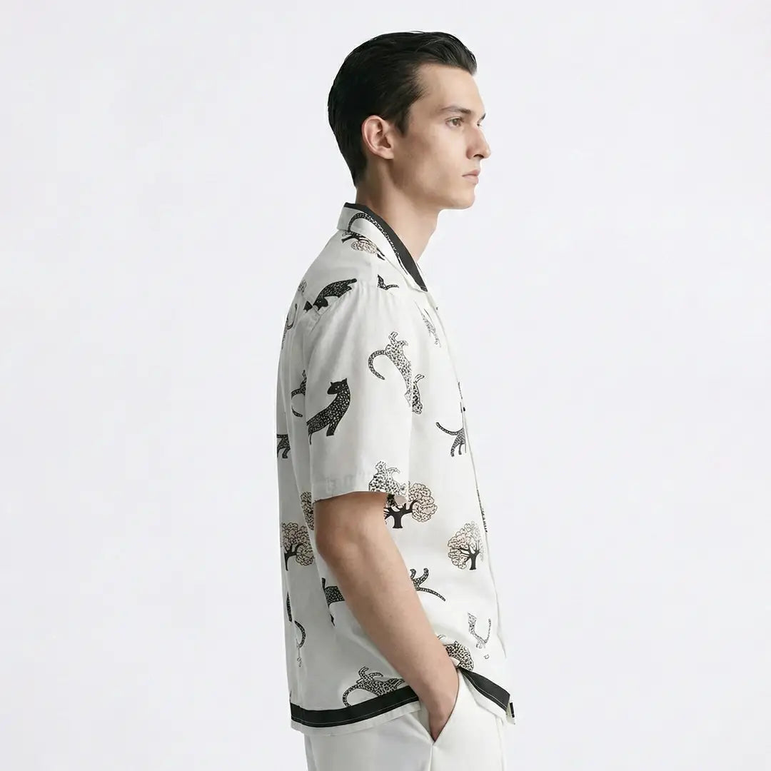 Man wearing a patterned shirt with a white background