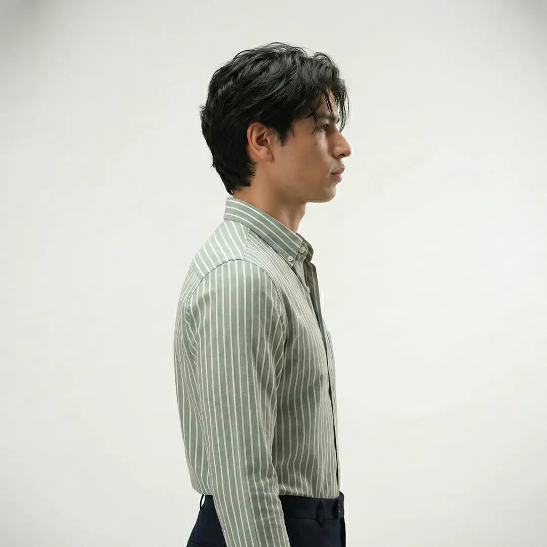 Man wearing a green striped shirt against a white background