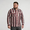 Man wearing a vertically striped shirt with red, white, and brown colors on a plain background