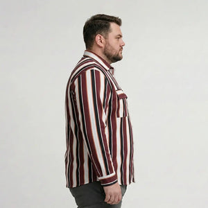 Man wearing a striped shirt against a plain background
