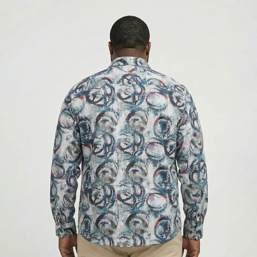 Man wearing a patterned shirt with a white background