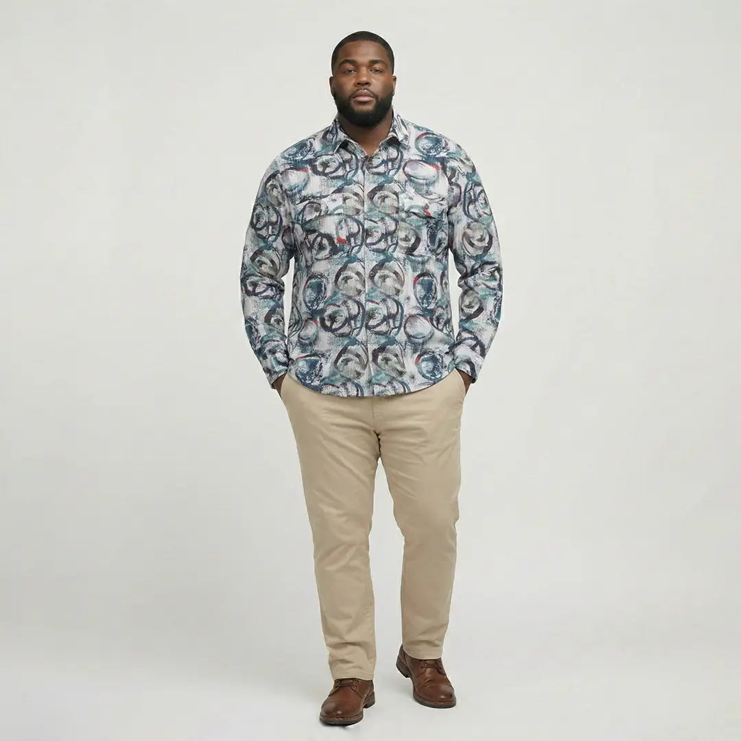 Man wearing a patterned shirt and beige pants on a white background