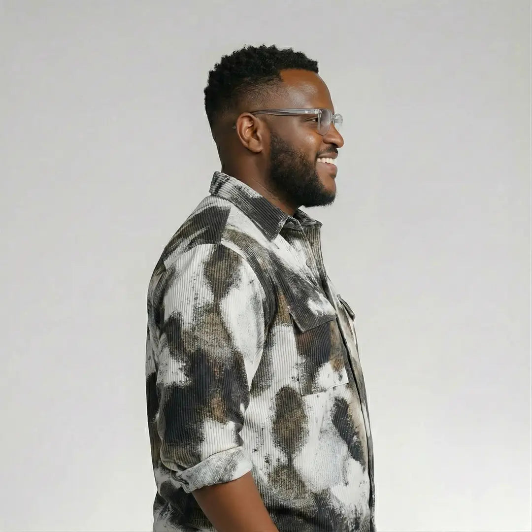 Man wearing a patterned shirt against a plain background