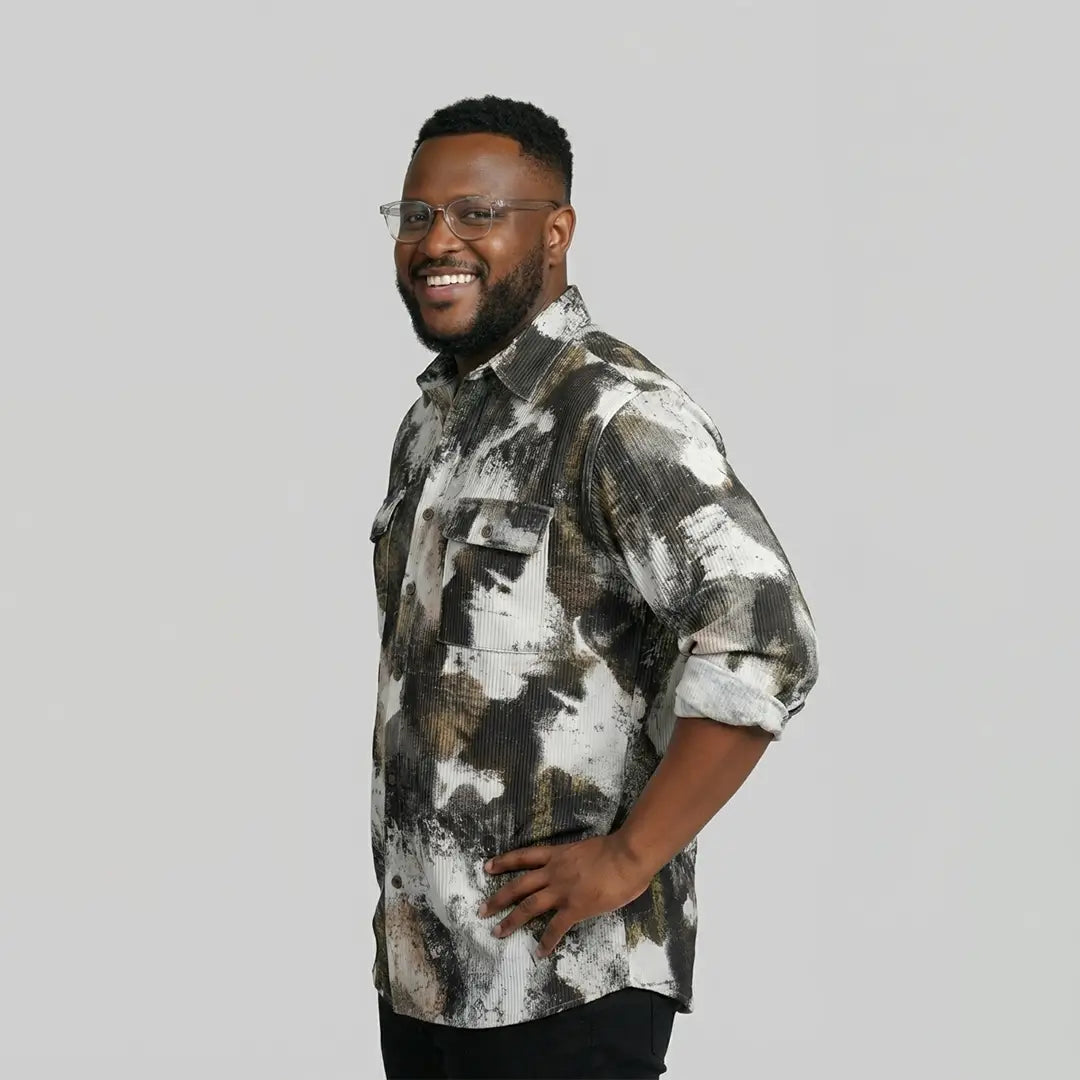 Man wearing a patterned shirt on a plain background